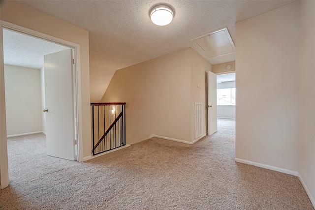 3022 Sam Houston Dr, Sugar Land, TX 77479 - hall with attic access, an upstairs landing, carpet floors, and a textured ceiling