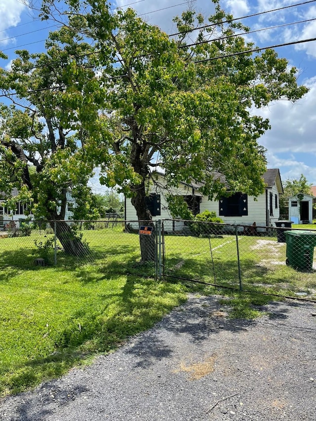 exterior space with a front lawn and a fenced front yard
