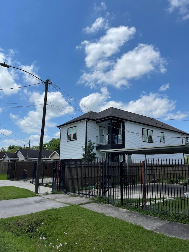 view of front of house with a fenced front yard and a balcony