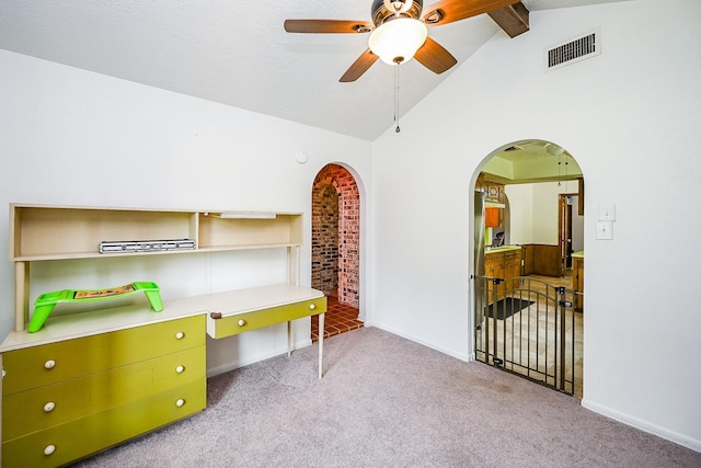 office featuring a ceiling fan, visible vents, arched walkways, baseboards, and carpet flooring