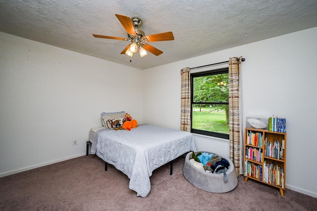 bedroom featuring a textured ceiling, baseboards, and carpet