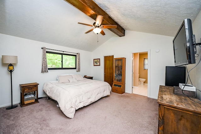 carpeted bedroom featuring lofted ceiling with beams, a textured ceiling, a ceiling fan, baseboards, and ensuite bathroom