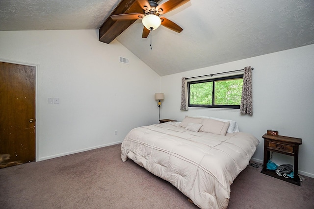 carpeted bedroom with vaulted ceiling with beams, a textured ceiling, baseboards, and visible vents
