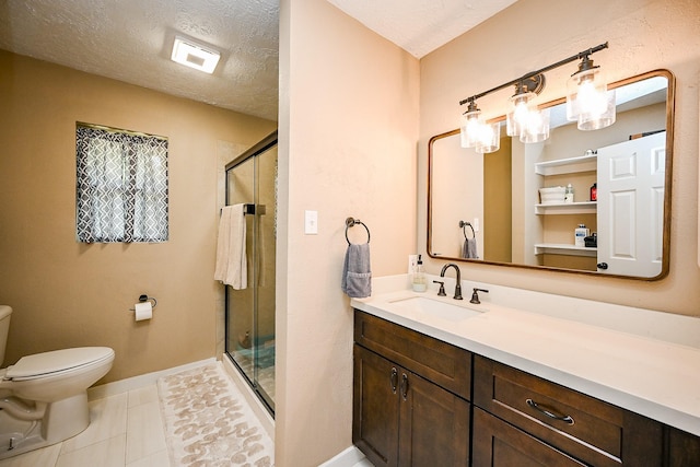 bathroom featuring vanity, toilet, a textured ceiling, baseboards, and a shower stall