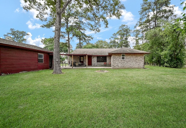 back of property with a patio and a lawn