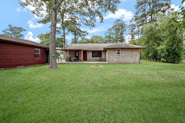 rear view of house with a lawn and a patio area