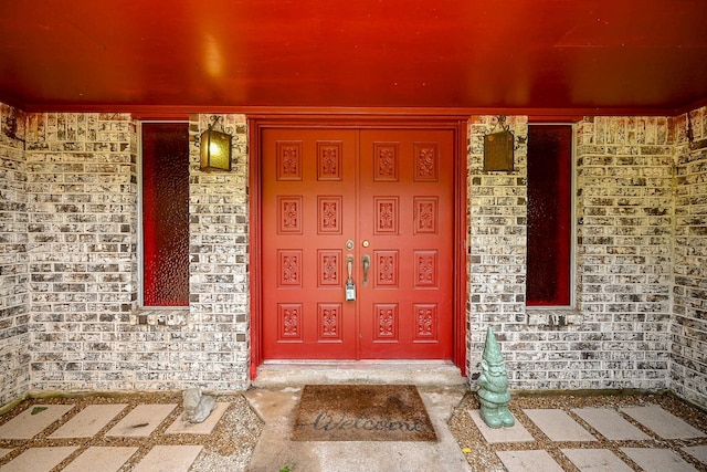 property entrance featuring a porch and stone siding