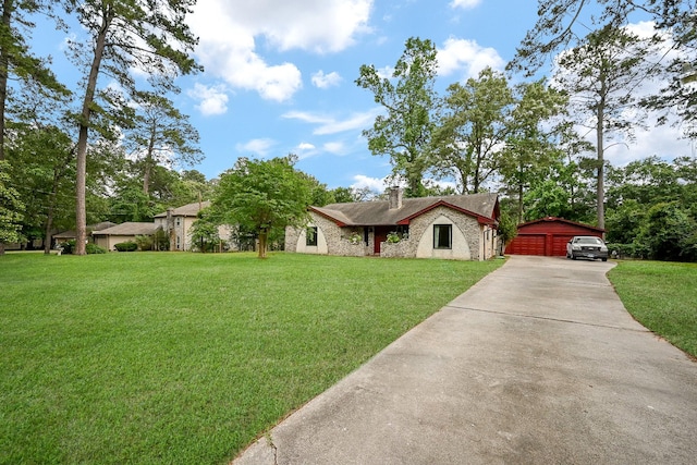ranch-style house with concrete driveway, a front yard, a chimney, and stone siding