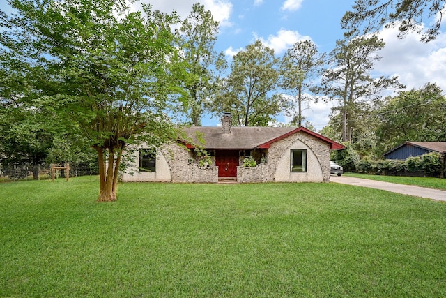 ranch-style home featuring driveway, a chimney, a front yard, brick siding, and fence