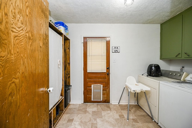 laundry area with a textured ceiling, stone finish flooring, cabinet space, and washer and dryer