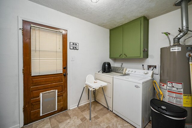 14135 Limerick Ln, Tomball, TX 77375 - washroom featuring water heater, washer and clothes dryer, cabinet space, a textured ceiling, and baseboards