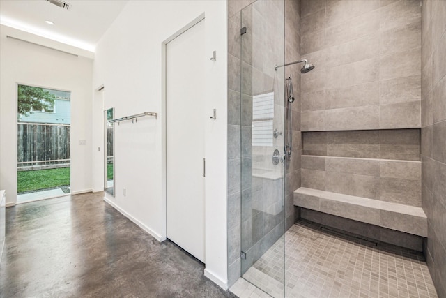 full bathroom with a shower stall and concrete floors