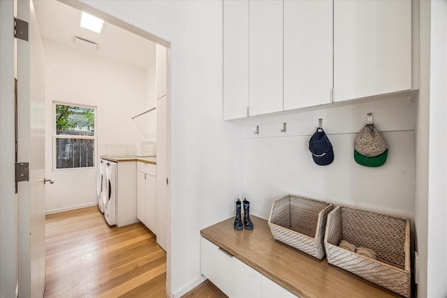 mudroom with baseboards, light wood-style flooring, and washer / clothes dryer
