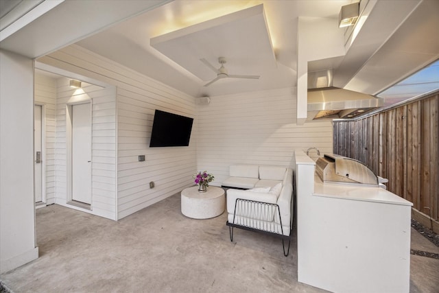 laundry area with ceiling fan, wood walls, and washing machine and dryer