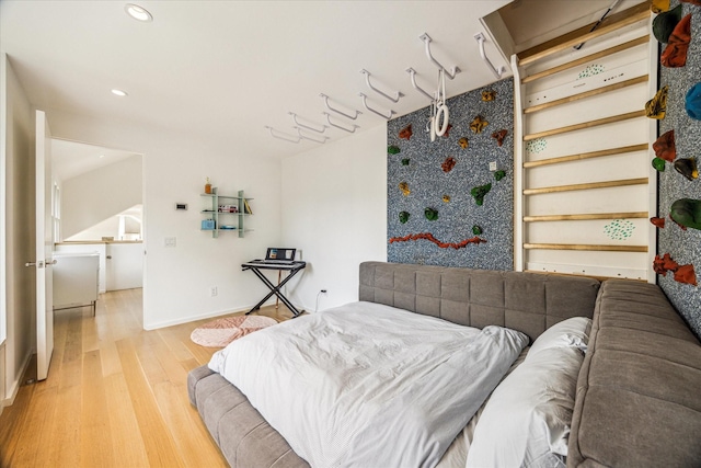 bedroom with baseboards, recessed lighting, and light wood-style flooring