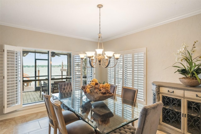 dining area with ornamental molding, a water view, light tile patterned flooring, and a chandelier