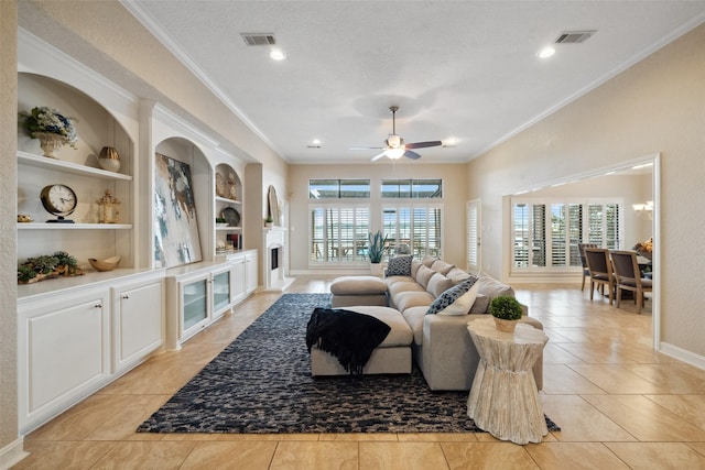 living room with ornamental molding, ceiling fan, light tile patterned floors, and a fireplace