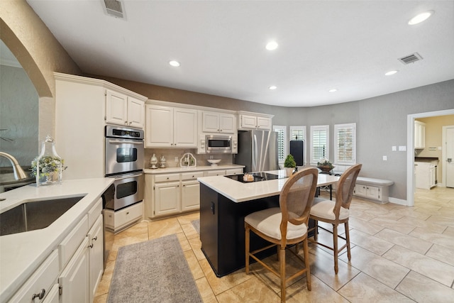kitchen featuring visible vents, a sink, appliances with stainless steel finishes, and recessed lighting