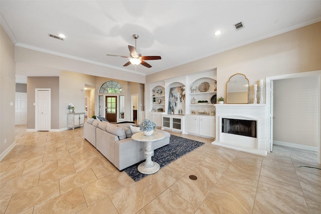 living room with crown molding, a fireplace with raised hearth, ceiling fan, and visible vents