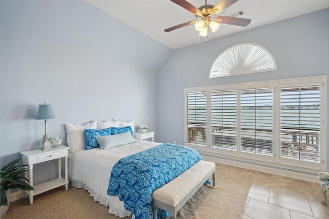 bedroom featuring a ceiling fan, tile patterned flooring, visible vents, and vaulted ceiling