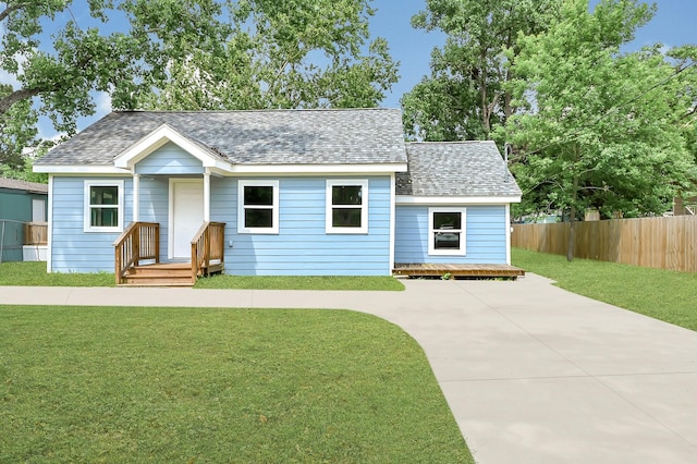 2114 Lone Star St, La Marque, TX 77568 - single story home with fence, a shingled roof, driveway, and a front yard