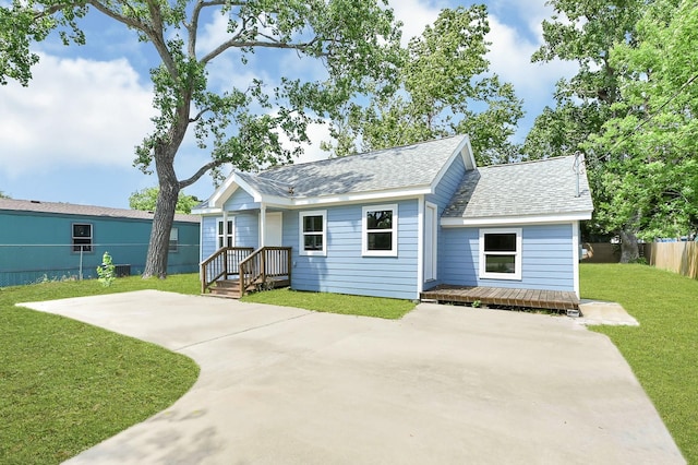 2114 Lone Star St, La Marque, TX 77568 - exterior space featuring roof with shingles, fence, concrete driveway, and a lawn