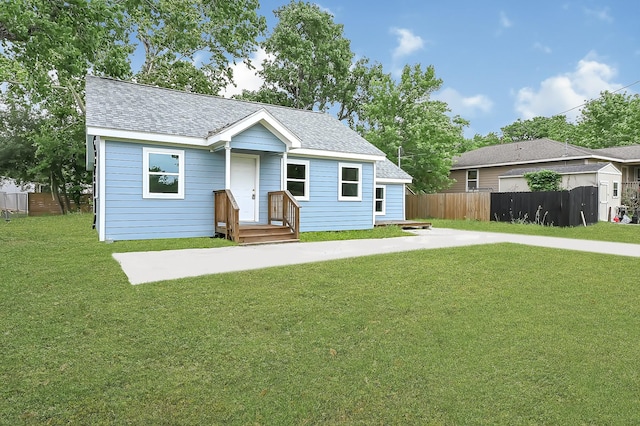 2114 Lone Star St, La Marque, TX 77568 - view of front of house with fence, roof with shingles, and a front yard