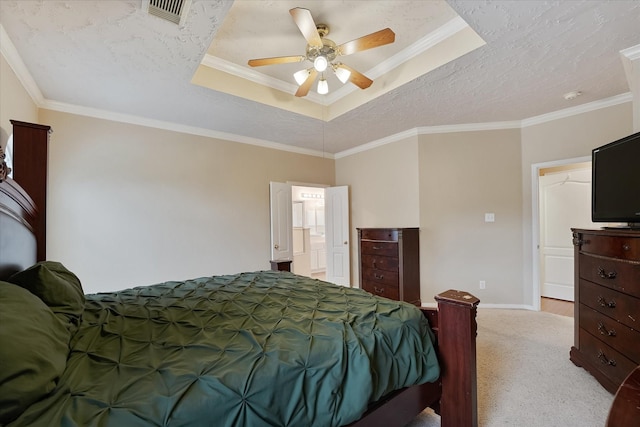 bedroom with crown molding, visible vents, baseboards, light colored carpet, and a tray ceiling