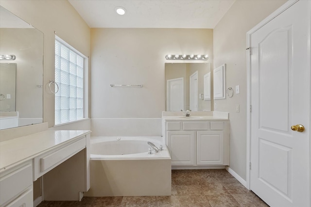 bathroom with vanity and a garden tub