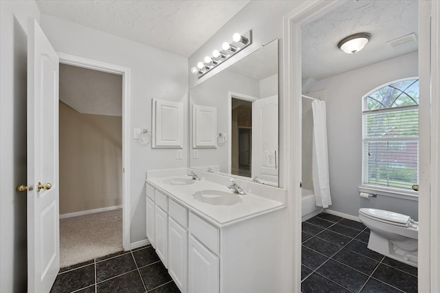 bathroom featuring visible vents, a sink, tile patterned floors, and toilet