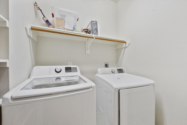 washroom featuring washing machine and clothes dryer and laundry area