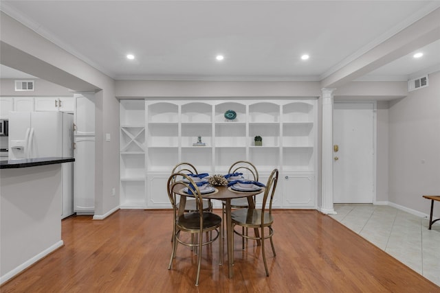 dining room with baseboards, ornamental molding, ornate columns, and visible vents