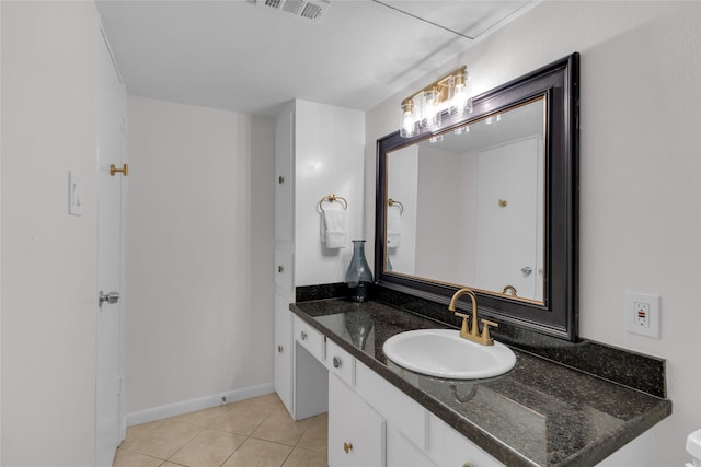 bathroom featuring tile patterned floors, baseboards, vanity, and visible vents