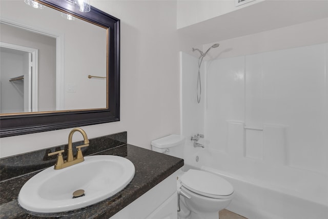 bathroom with toilet, bathing tub / shower combination, and vanity
