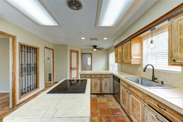 17522 Sorrel Ridge Dr, Spring, TX 77388 - kitchen with a sink, stainless steel dishwasher, tile countertops, black electric cooktop, and a peninsula