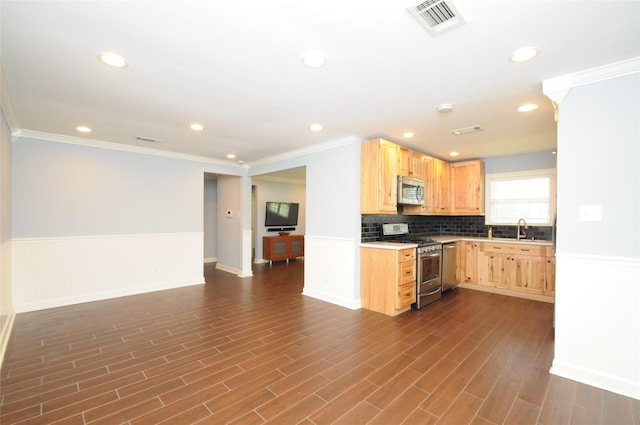 1246 W 21st St, Houston, TX 77008 - kitchen featuring stainless steel appliances, light brown cabinets, open floor plan, a wainscoted wall, and recessed lighting