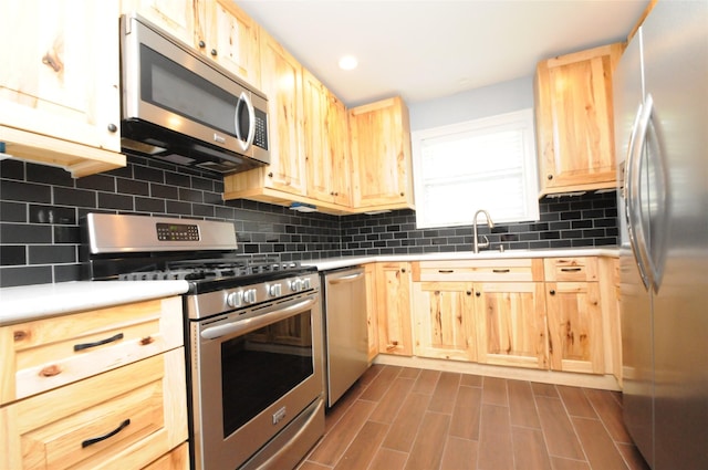 1246 W 21st St, Houston, TX 77008 - kitchen with stainless steel appliances, light brown cabinets, a sink, tasteful backsplash, and light countertops