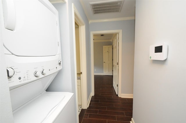 1246 W 21st St, Houston, TX 77008 - laundry area with stacked washer / dryer, ornamental molding, baseboards, and dark wood-style flooring