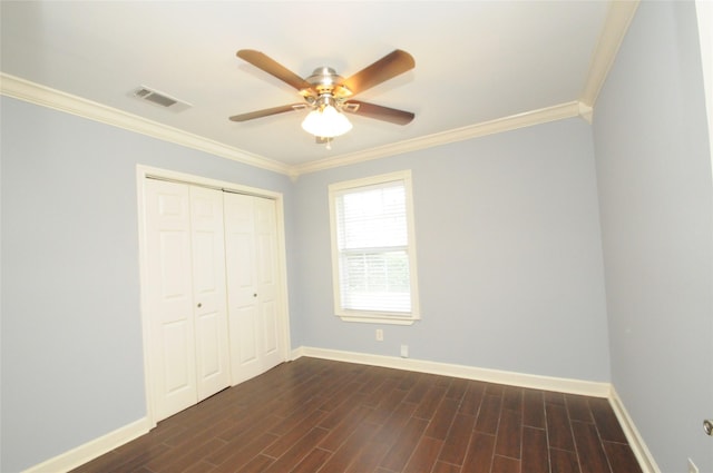 1246 W 21st St, Houston, TX 77008 - unfurnished bedroom with ornamental molding, baseboards, a closet, dark wood-type flooring, and ceiling fan