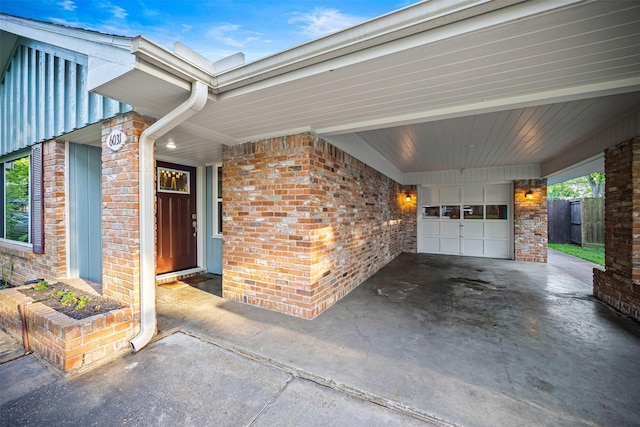 exterior space featuring fence, concrete driveway, and brick siding