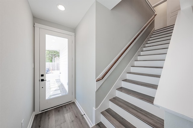 foyer with stairs, recessed lighting, baseboards, and wood finished floors