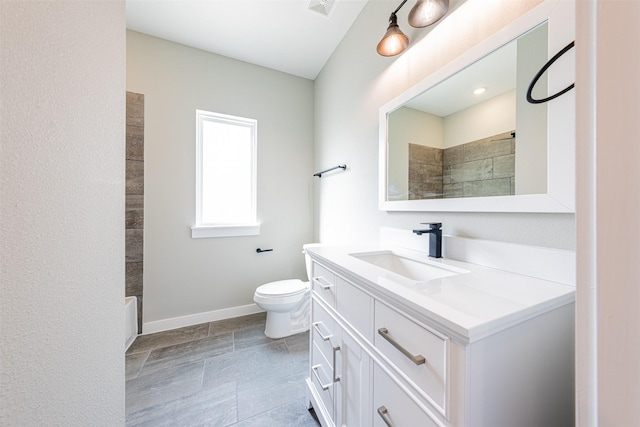 full bathroom featuring vanity, baseboards, walk in shower, and toilet