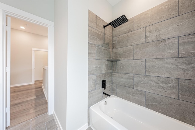 full bath with baseboards, shower / tub combination, and wood finished floors