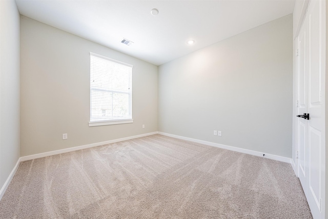 carpeted empty room featuring recessed lighting, baseboards, and visible vents