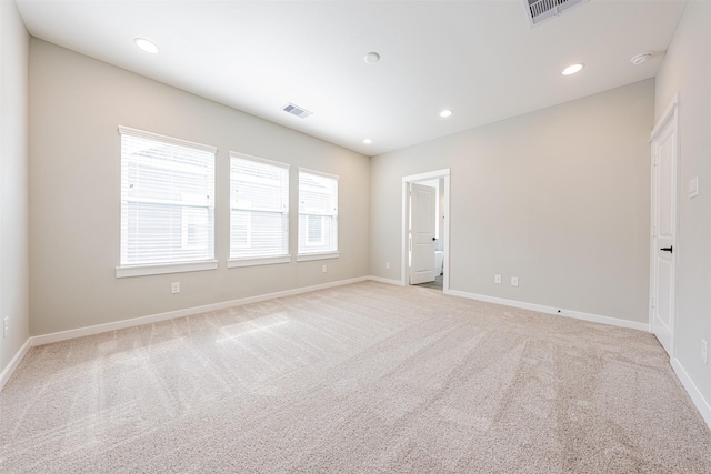 spare room with baseboards, carpet flooring, and visible vents