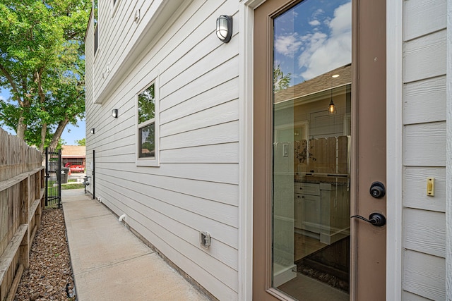 view of side of home featuring fence