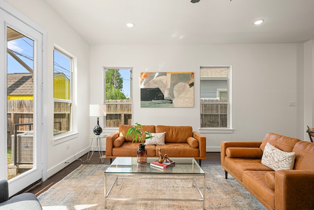 living area with recessed lighting, wood finished floors, and a wealth of natural light