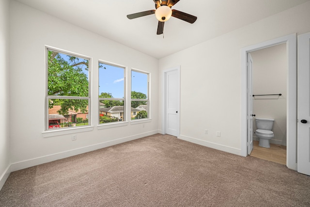 unfurnished bedroom with baseboards, carpet, and ensuite bath
