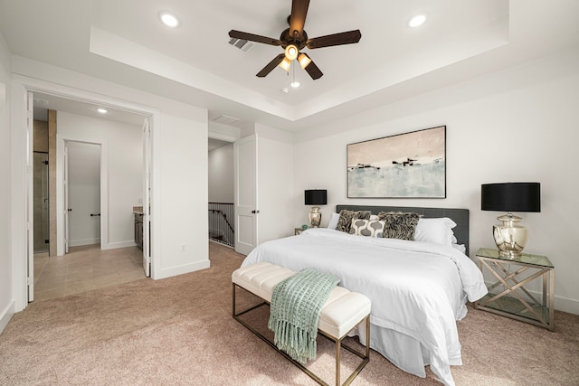 bedroom with carpet flooring, recessed lighting, a tray ceiling, and baseboards