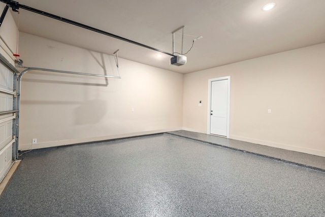 garage featuring recessed lighting, baseboards, and a garage door opener